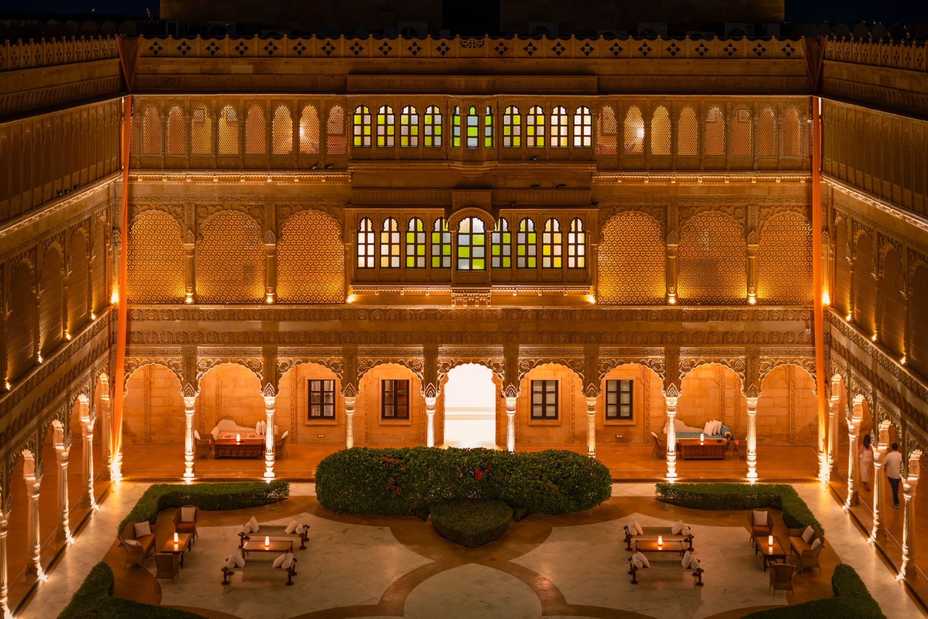Stunning night view of a beautifully lit palace courtyard in Jaisalmer, Rajasthan, India, showcasing exquisite architecture.
