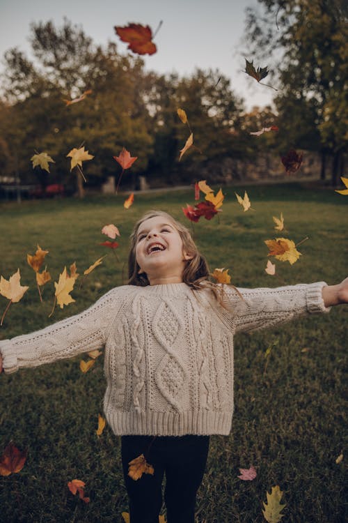 Free Girl Wearing Knitted Sweater Standing Outside With Leaves Falling Stock Photo
