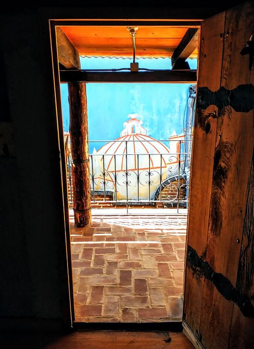 Free View through an open door to a traditional rooftop in San Cristobal de las Casas, Mexico. Stock Photo