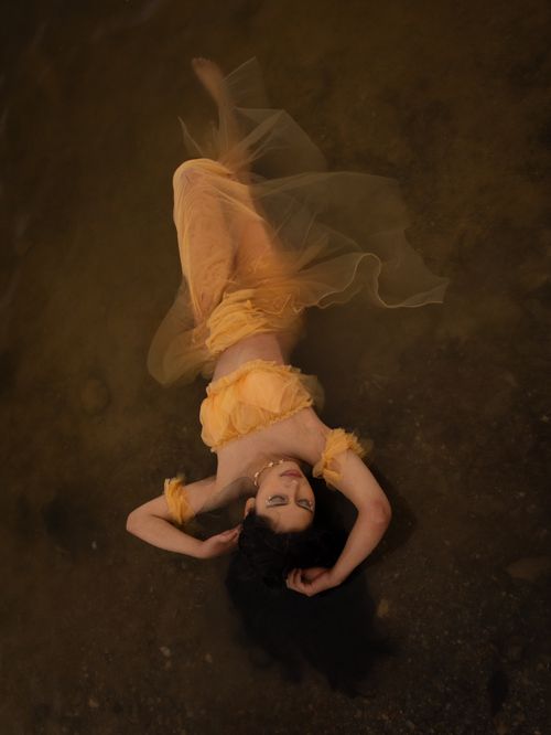 Elegant Woman in Traditional Dress Lying in Water · Free Stock Photo