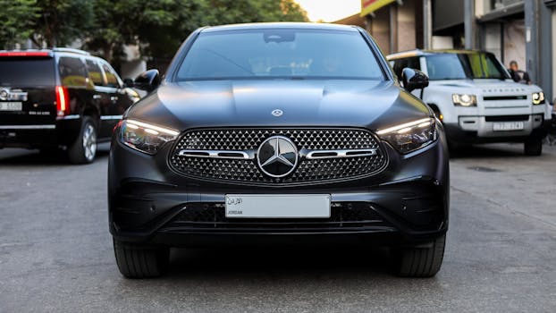 Front view of a sleek Mercedes-Benz SUV in a city setting, showcasing luxury in Amman, Jordan.