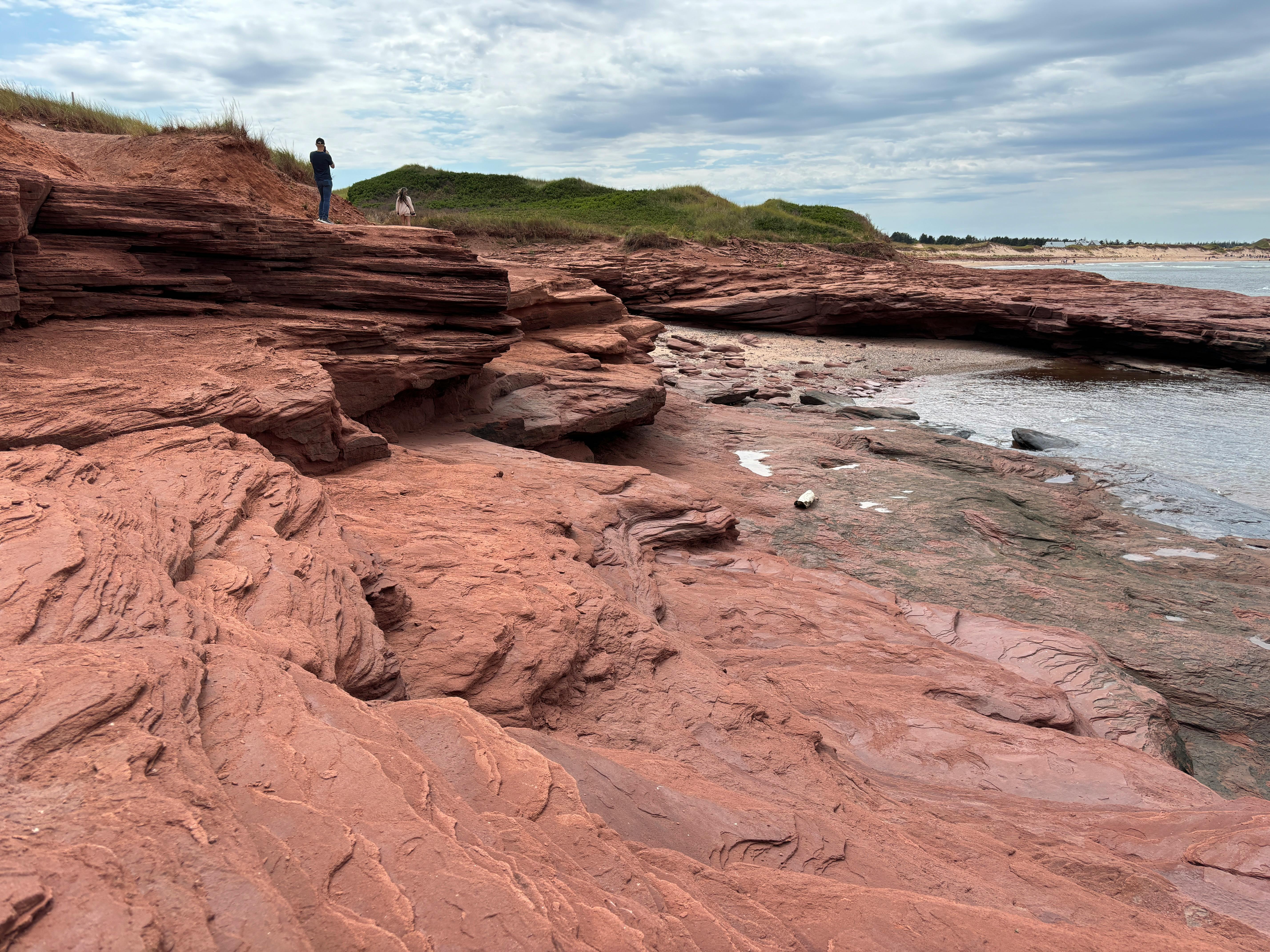 Explore the stunning red sandstone cliffs along the shore in Cavendish, PEI, Canada.