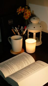 A warm and inviting reading nook lit by candlelight, perfect for cozy evenings with a good book.