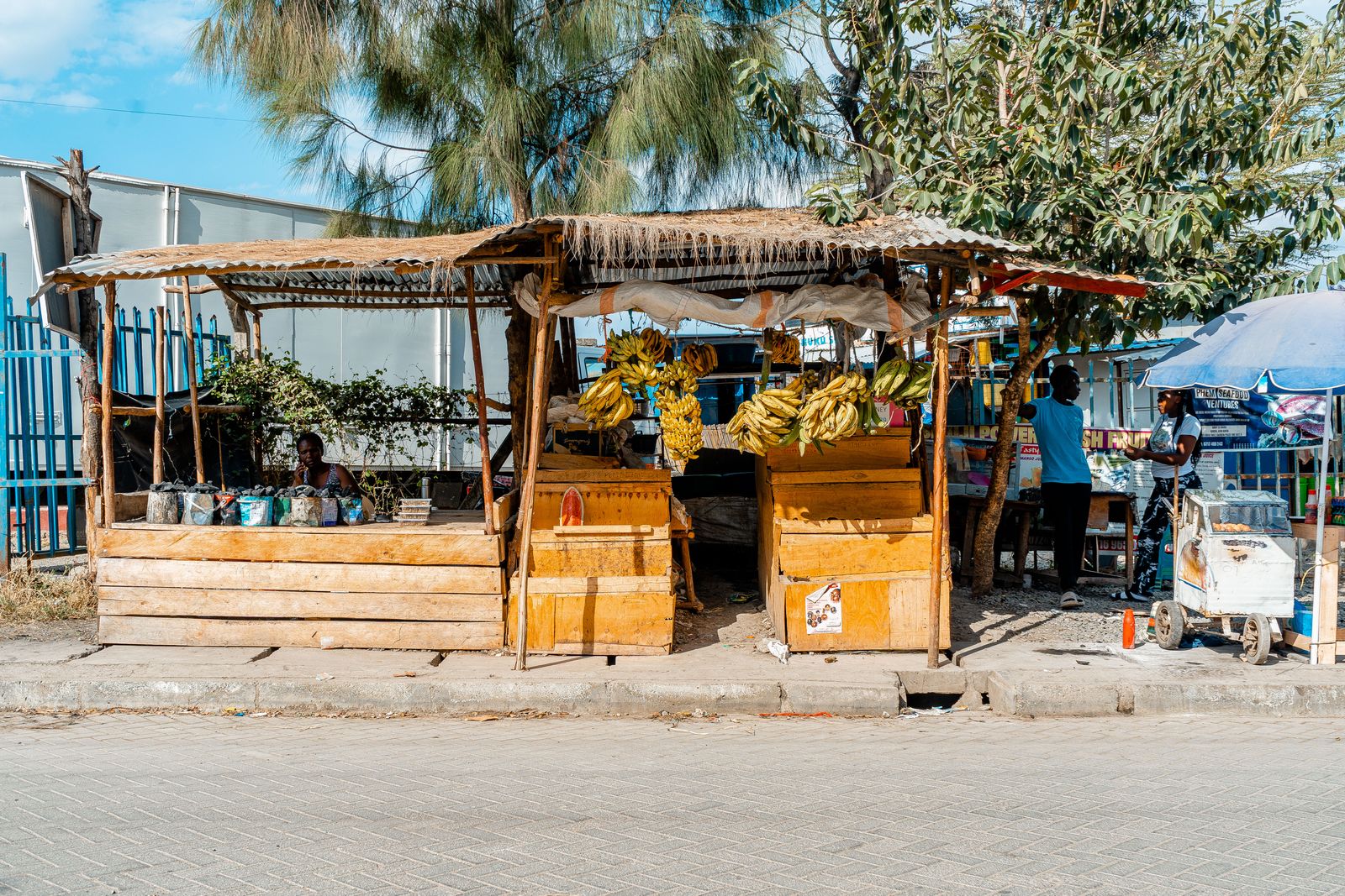 A fruit and banana stall beside a Nairobi street with local vendors
