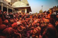 Vibrant celebration of Holi in India with colorful powders and traditional attire.