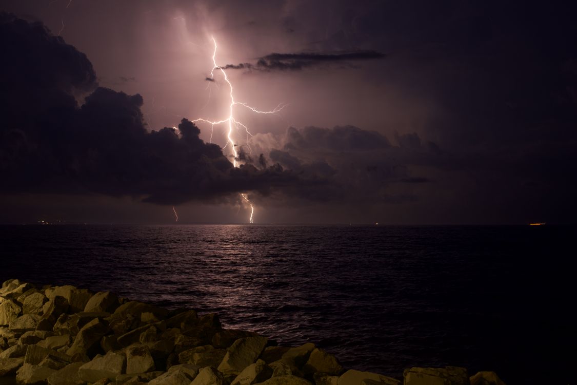 Dramatic Lightning Storm Over Ocean at Night · Free Stock Photo