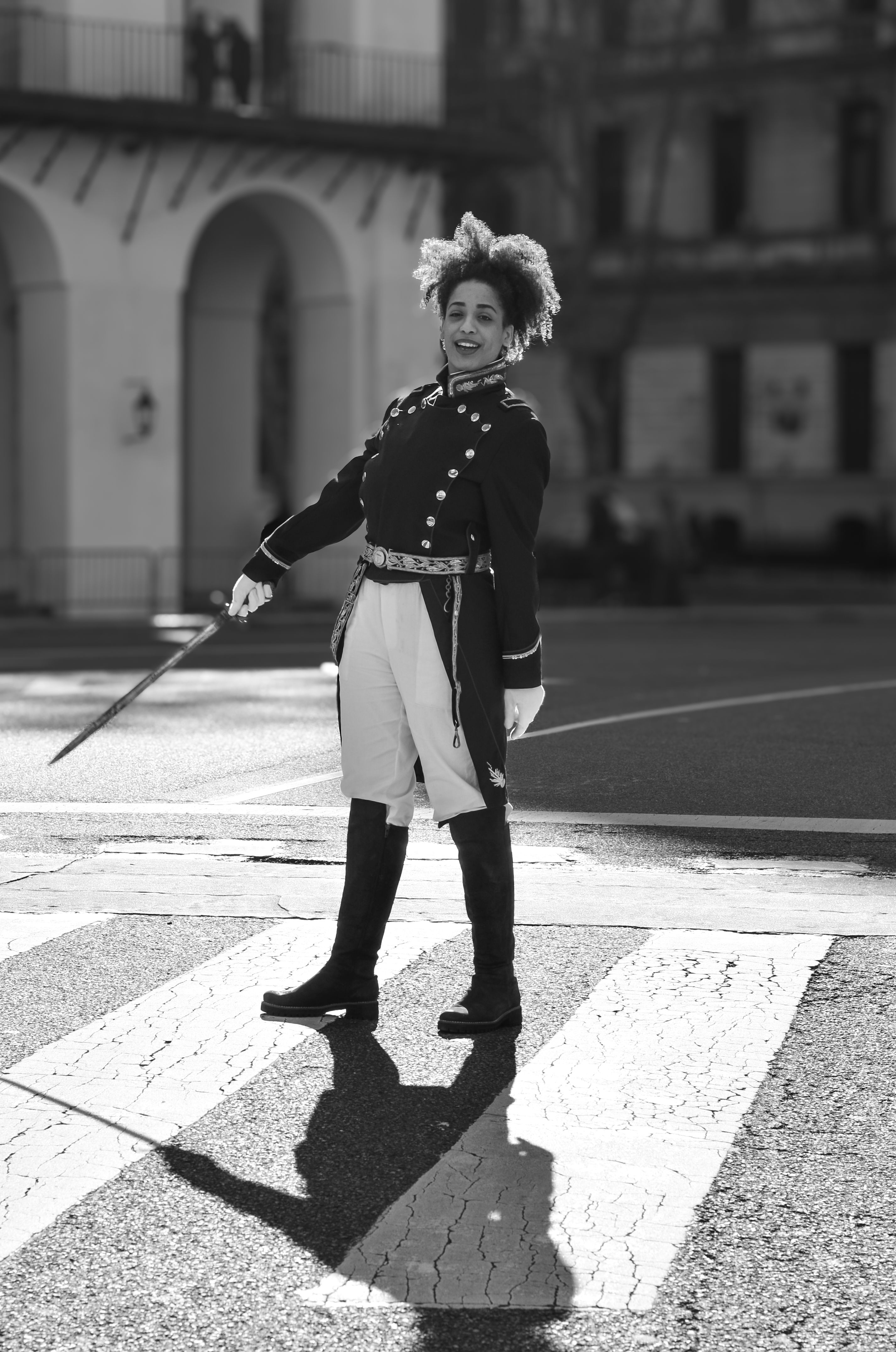 Black and white portrait of a person in historic military costume standing in Buenos Aires.