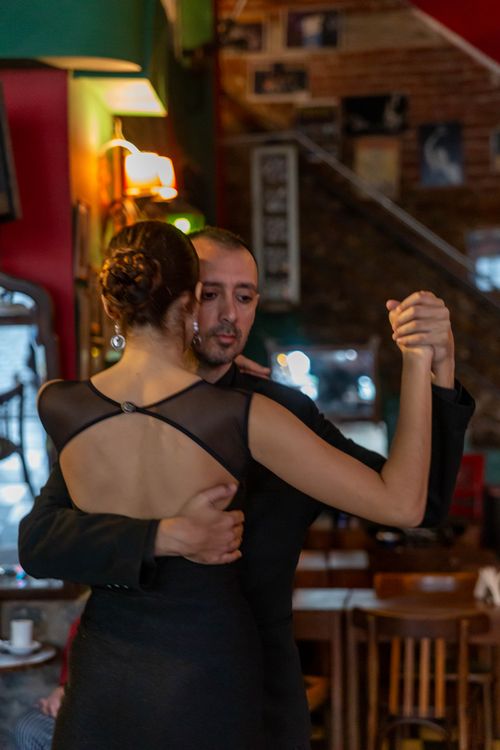 Free A couple gracefully dances tango in a cozy Buenos Aires cafe setting. Stock Photo