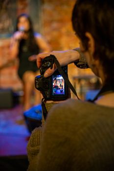 A photographer captures a music performance indoors in Mar del Plata, Argentina.
