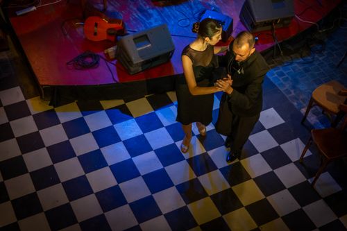 Free A couple gracefully dances tango in Mar del Plata, Argentina, on a checkered floor. Stock Photo