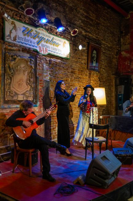 Tango musicians and dancers perform live in a vibrant Buenos Aires bar setting. — Fadista, Portugal.