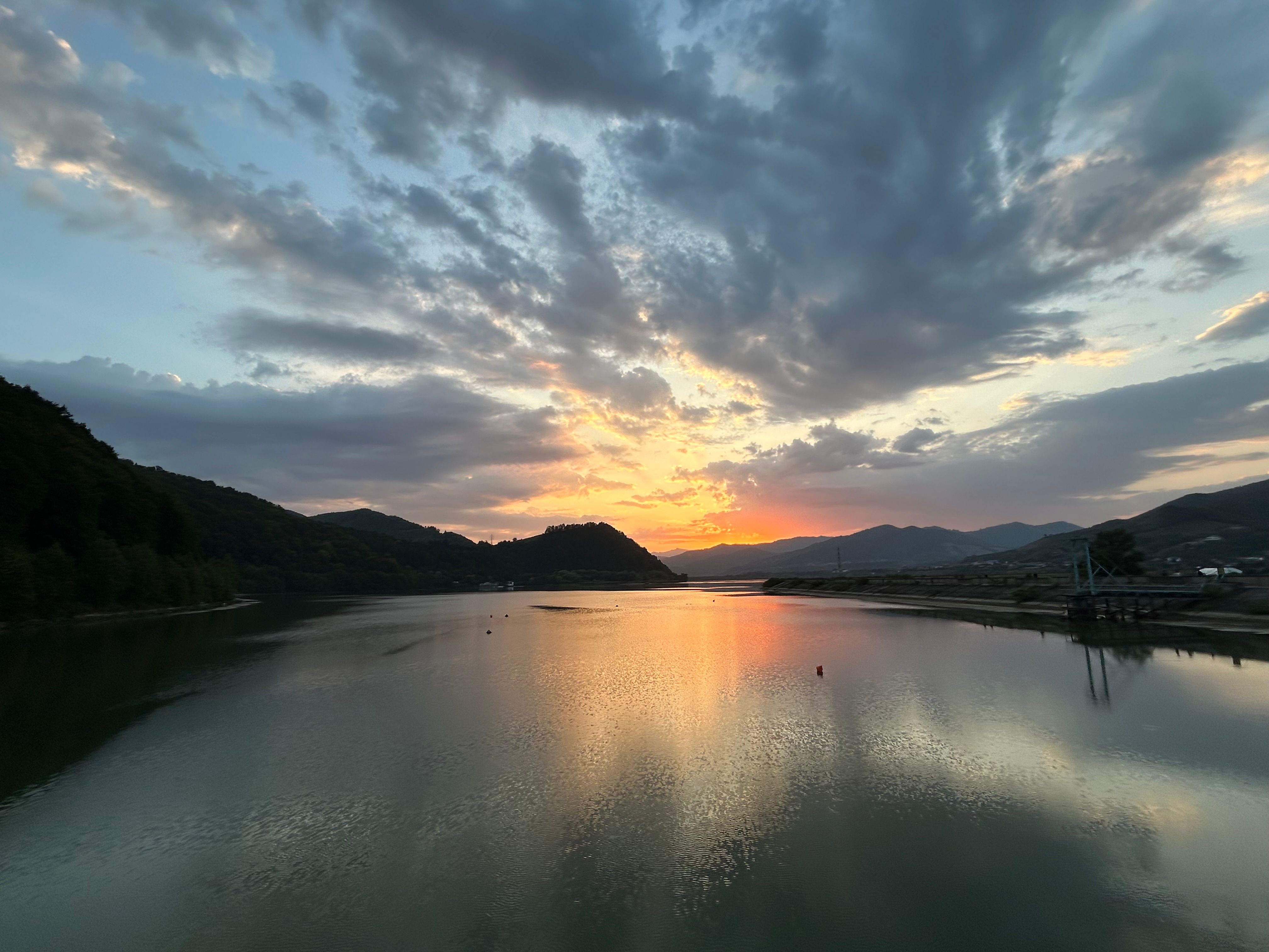 Clouds over a River at Sunset · Free Stock Photo