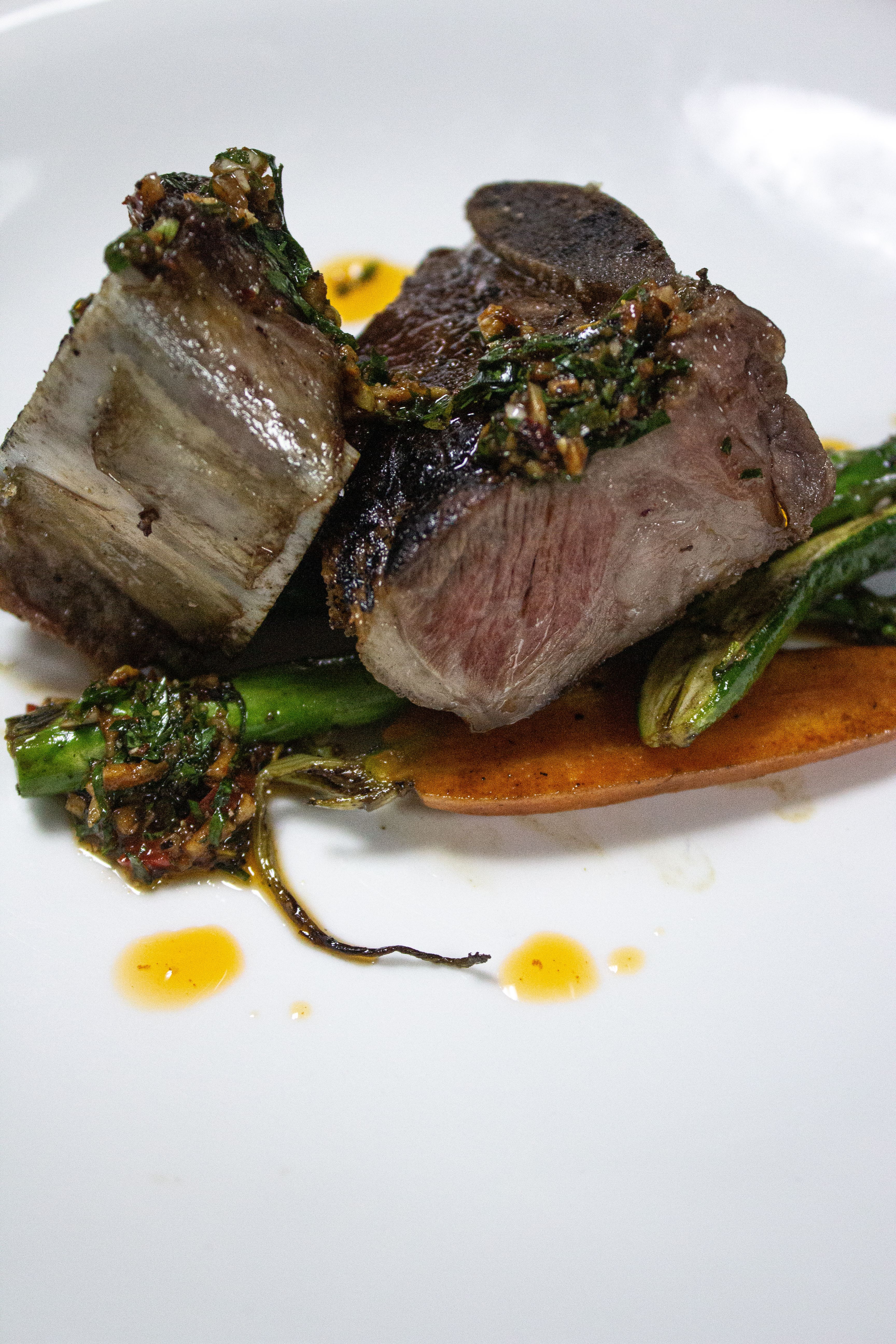 A gourmet beef dish served with vegetables and sauce, embodying luxury dining.