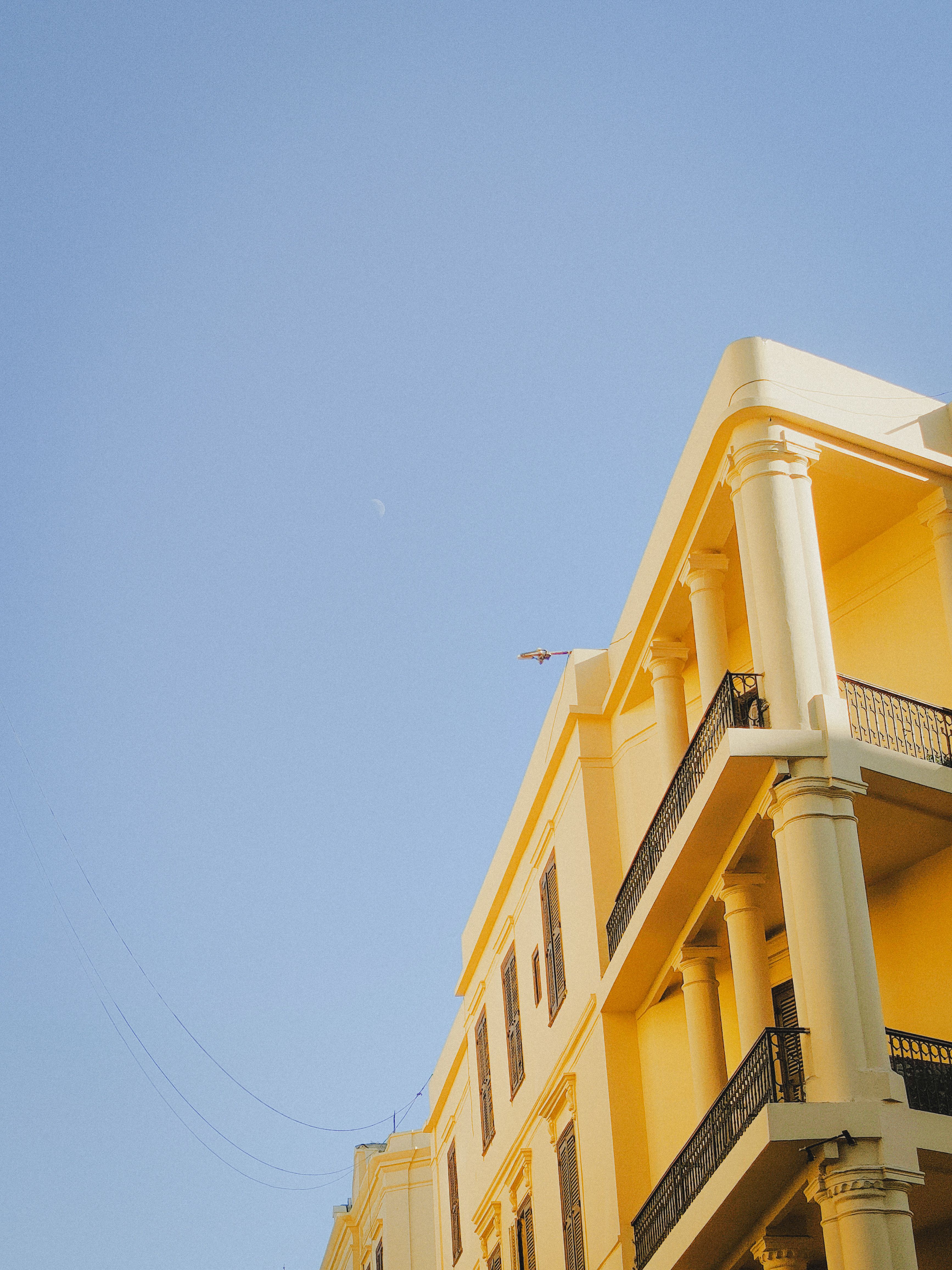 Yellow Building Against Clear Blue Sky · Free Stock Photo
