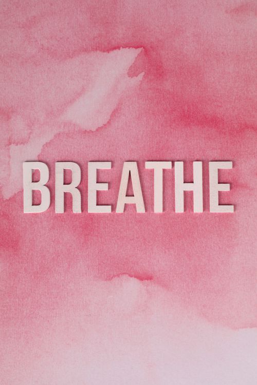 Free Breathe text on a calming pink watercolor background for mindfulness. Stock Photo
