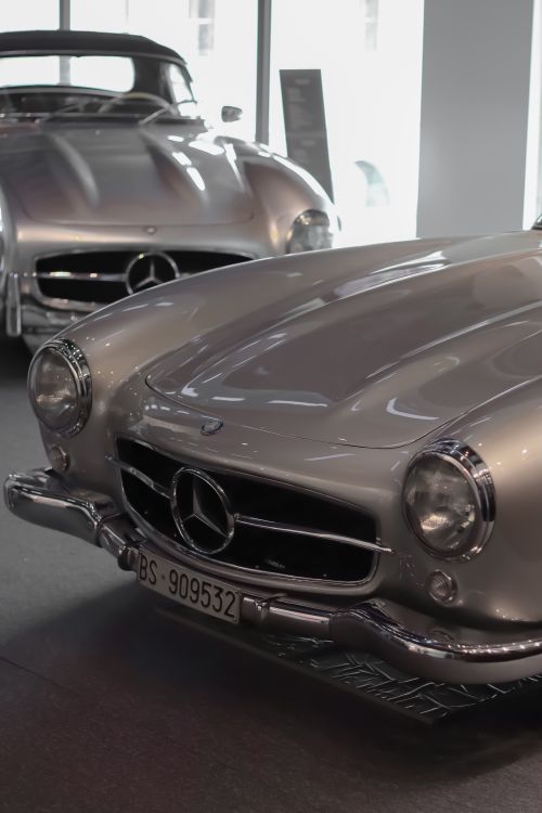 Free Classic Mercedes sports cars displayed in an indoor showroom, highlighting vintage automotive design. Stock Photo