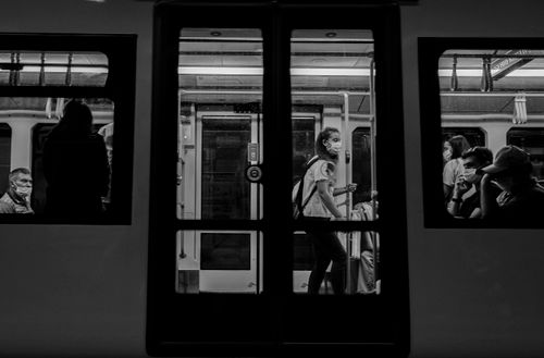 Free Passengers wearing masks in a subway in Bursa, Türkiye, captured in a black and white street photo. Stock Photo