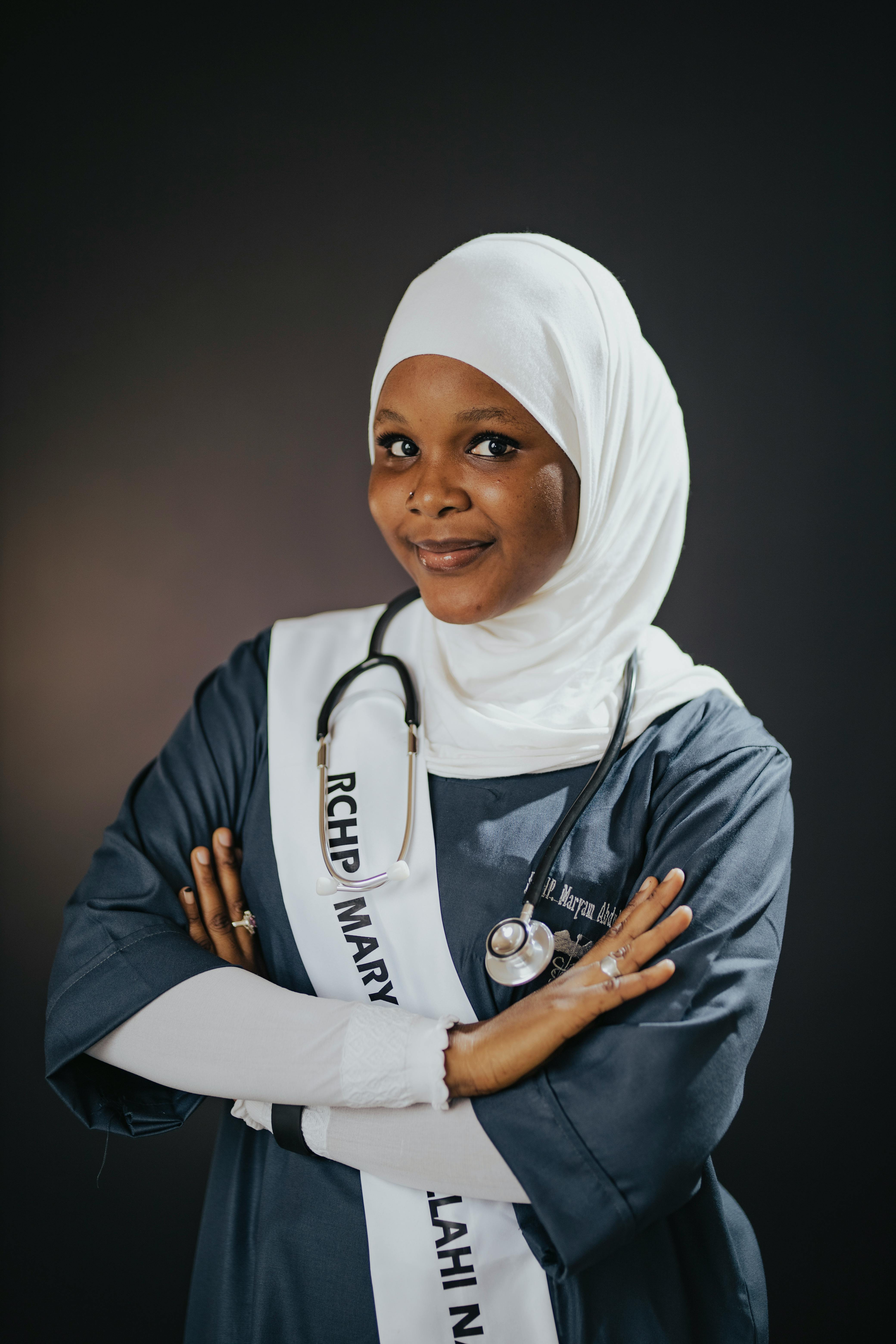 Portrait of a female medical graduate in hijab with stethoscope, exuding confidence.