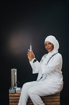 Confident female nurse in white uniform and hijab preparing a syringe for injection, symbolizing healthcare professionalism.