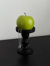 Green Apple on Black Stand Minimalist Still Life
