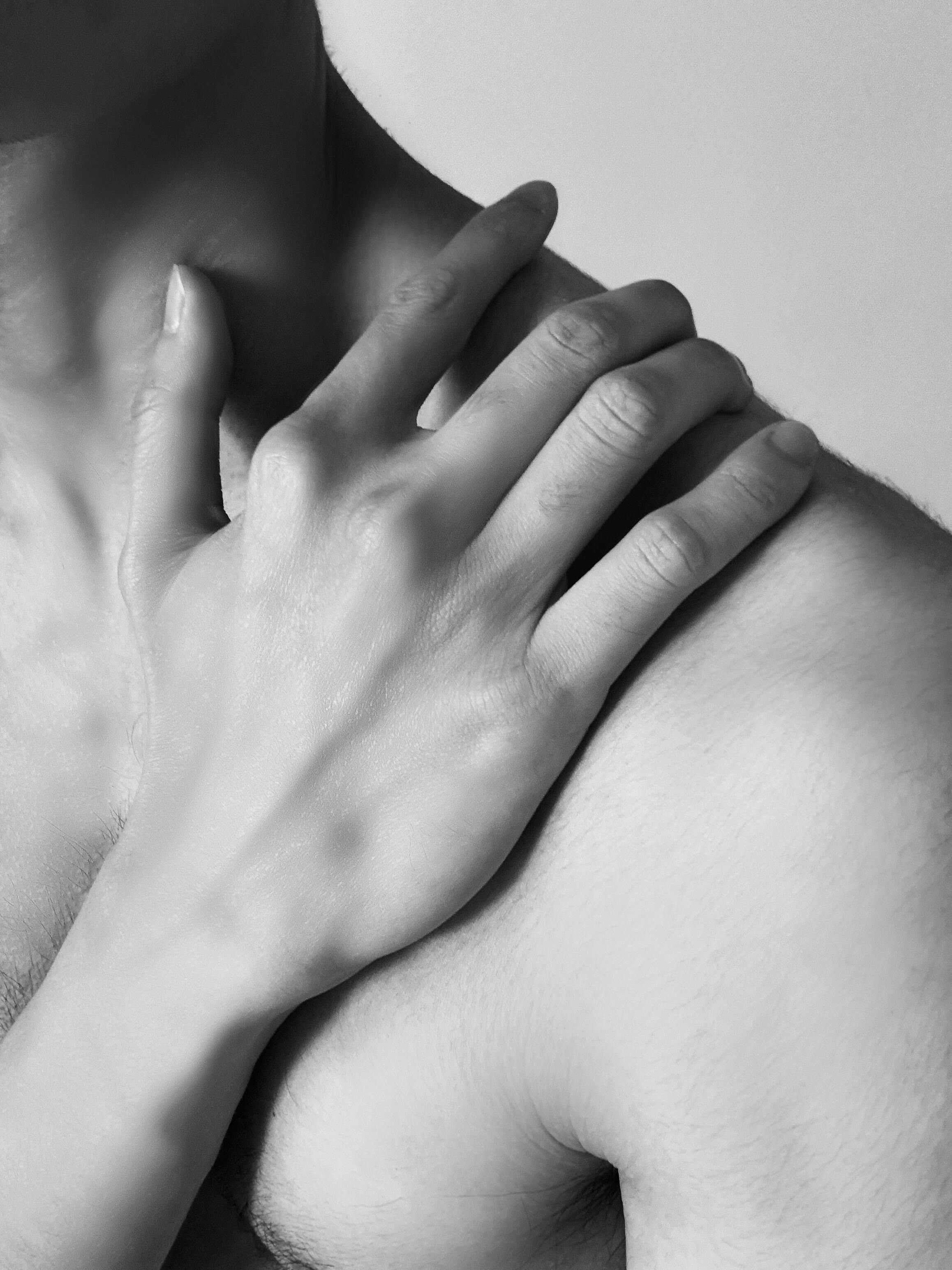 Artistic Close-Up of Hand on Shoulder in Black and White · Free Stock Photo