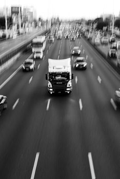 Monochromatic view of busy highway traffic in Buenos Aires, highlighting dynamic urban life.
