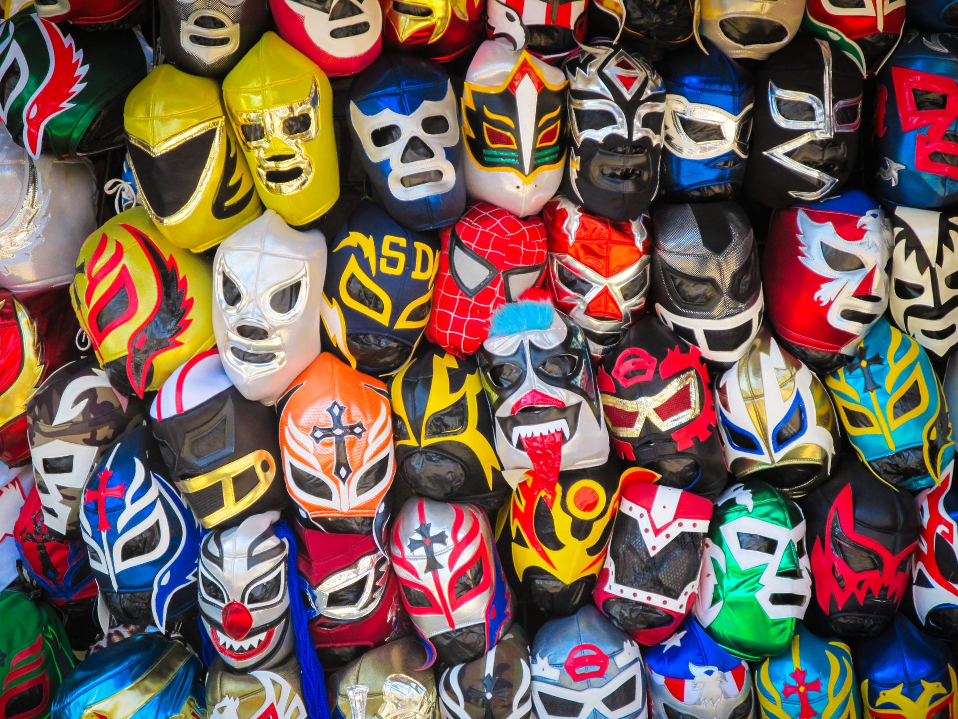 Colorful display of lucha libre masks showcasing Mexican wrestling culture.