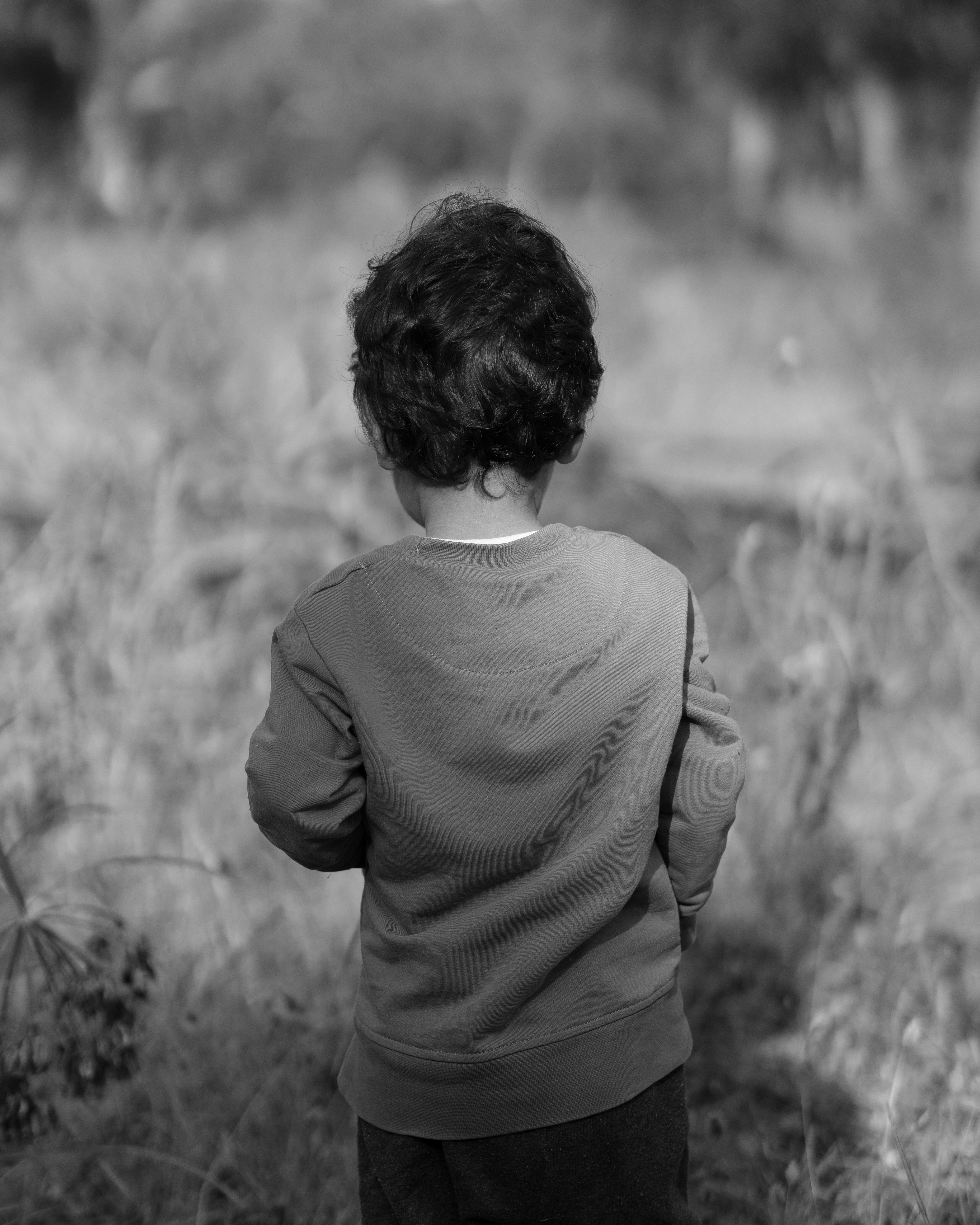 Child wearing a cozy plain sweatshirt outdoors