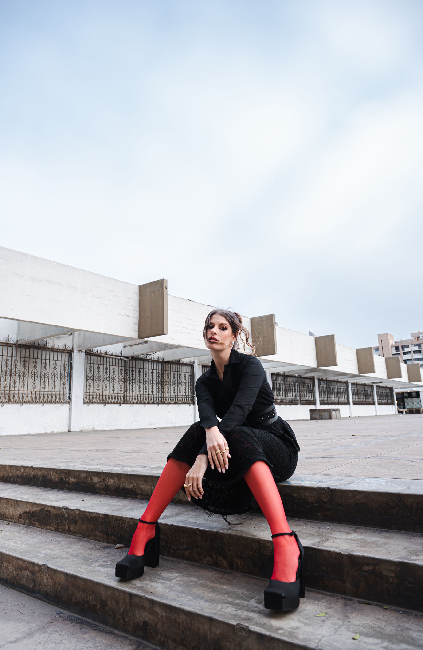 A woman in red stockings leaning against a wall  Free Stock Photo