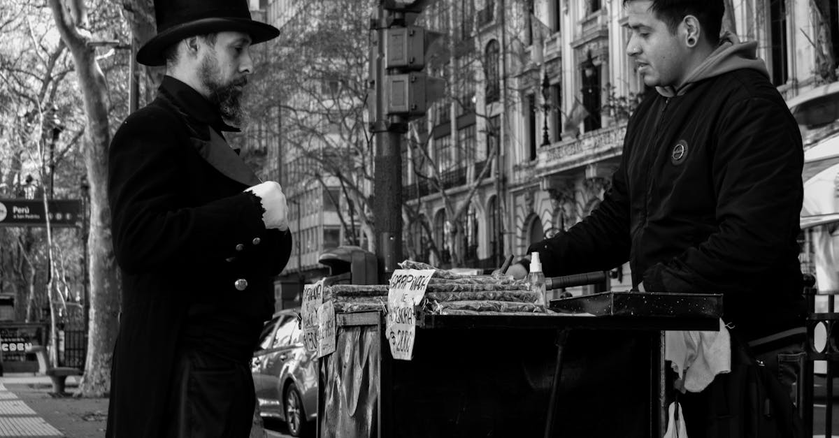 A candid shot capturing two men in conversation by a street food cart in Buenos Aires.
