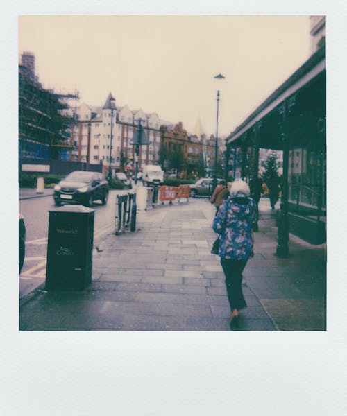 Woman Standing on Sidewalk