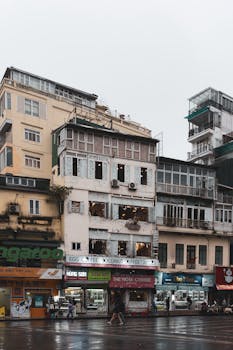 Explore the architectural variety of Hanoi's urban landscape showcasing eclectic buildings and street life.