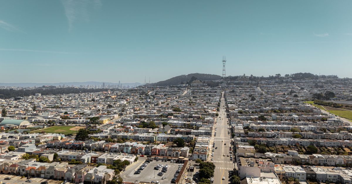 Aerial view of San Francisco showcasing the urban landscape and Sutro Tower under a clear sky.