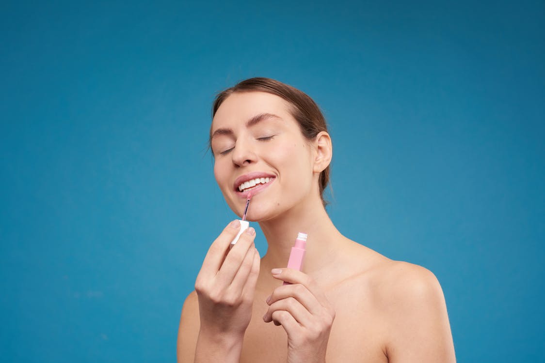 Free Woman Applying Lipstick Stock Photo