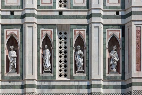 Free Close-up of a Gothic-style facade with sculptures in Florence, Italy. Stock Photo