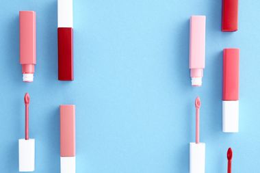 Lip products lined up on light blue, photo by Shiny Diamond on Pexels