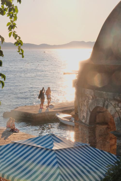 Free Scenic view of Zadar's waterfront during sunset with people enjoying the serene sea. Stock Photo