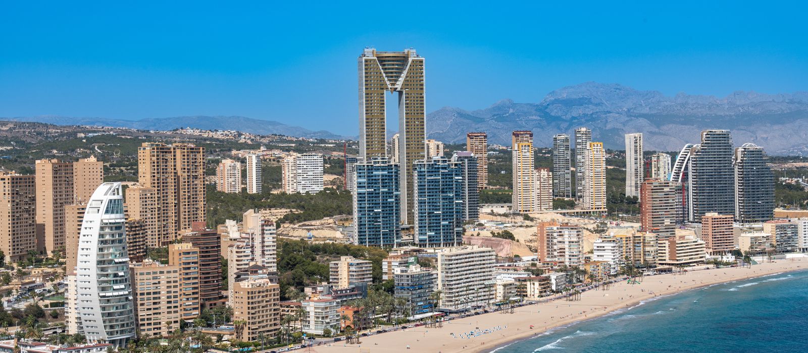 Aerial view of Benidorm's beachfront with iconic Intempo building.