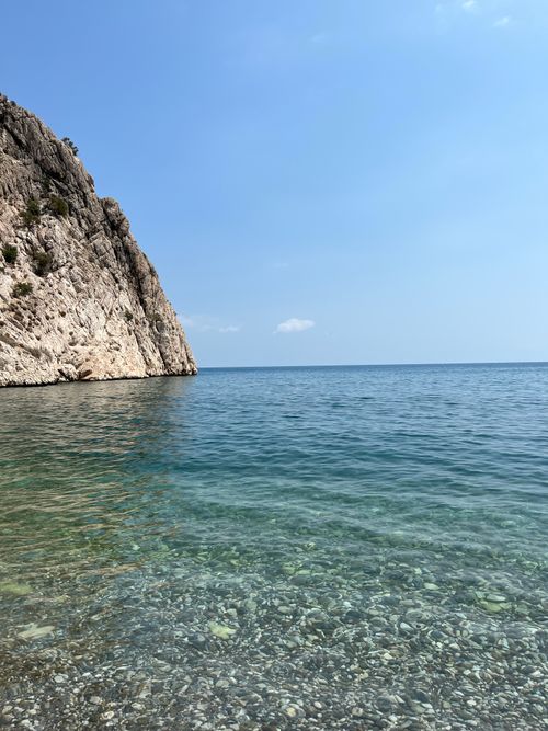 Free Stunning rocky coastline in Türkiye with clear blue waters and a bright sky. Stock Photo