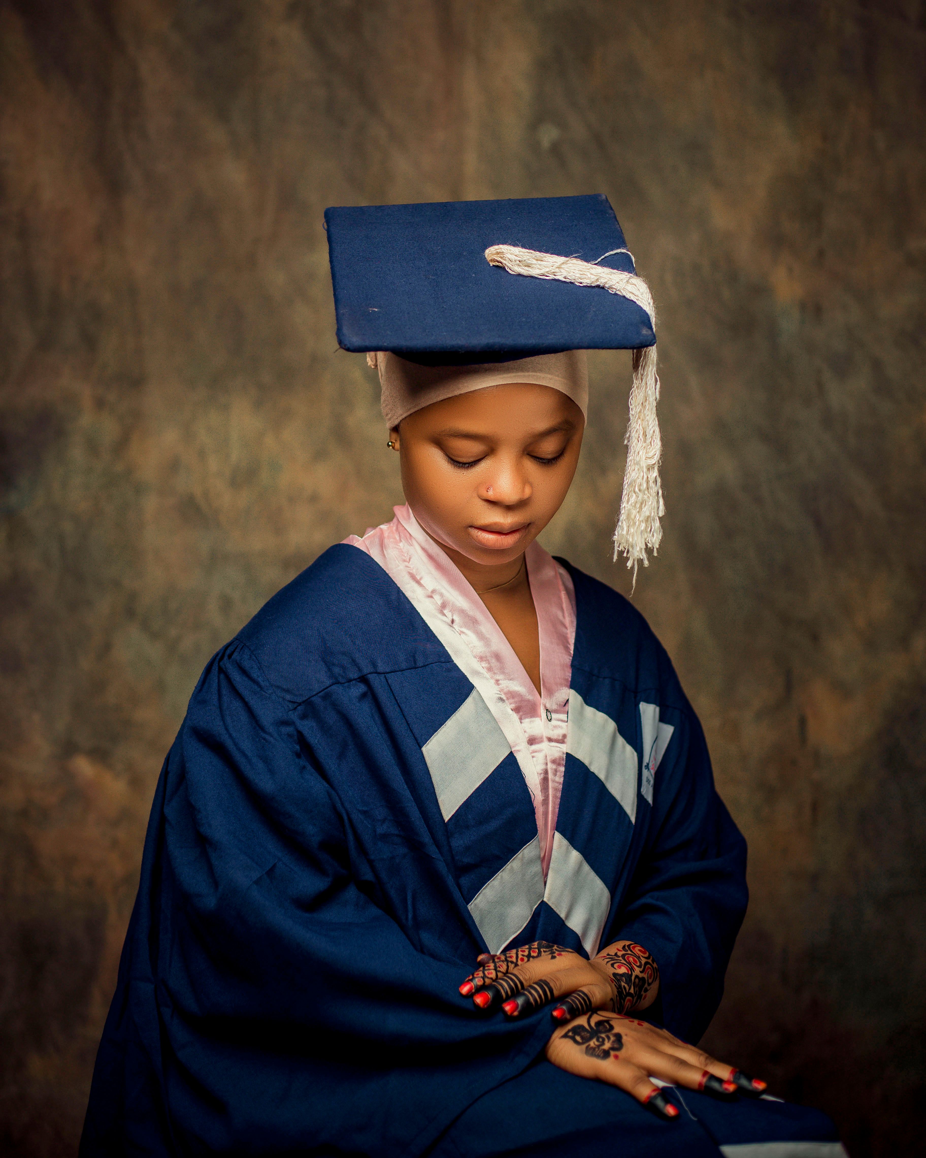 Young Woman in Graduation Cap and Gown Portrait · Free Stock Photo