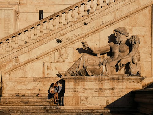 Free Photo Of Couple Kissing Beside Statue Stock Photo