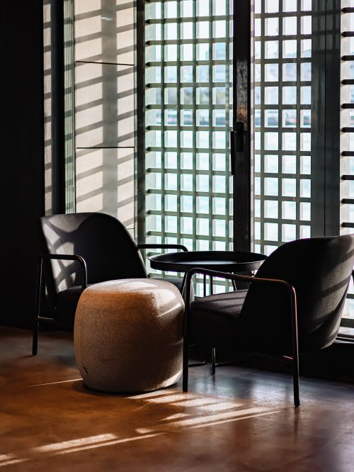 Free Sunlit minimalist lounge with stylish chairs and a table. Perfect for modern interiors. Stock Photo