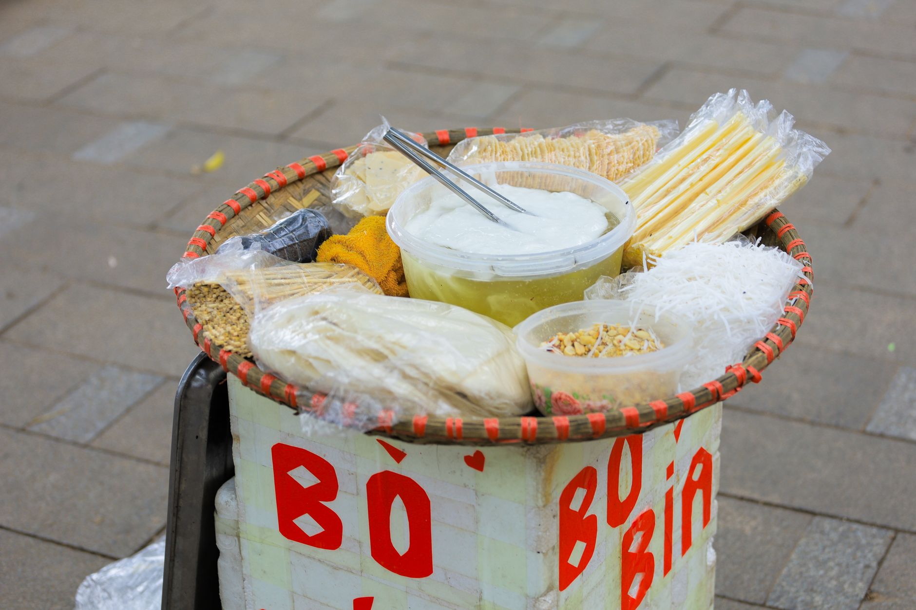 Traditional Vietnamese bò bía snacks displayed outdoors in Hà Nội, Vietnam.