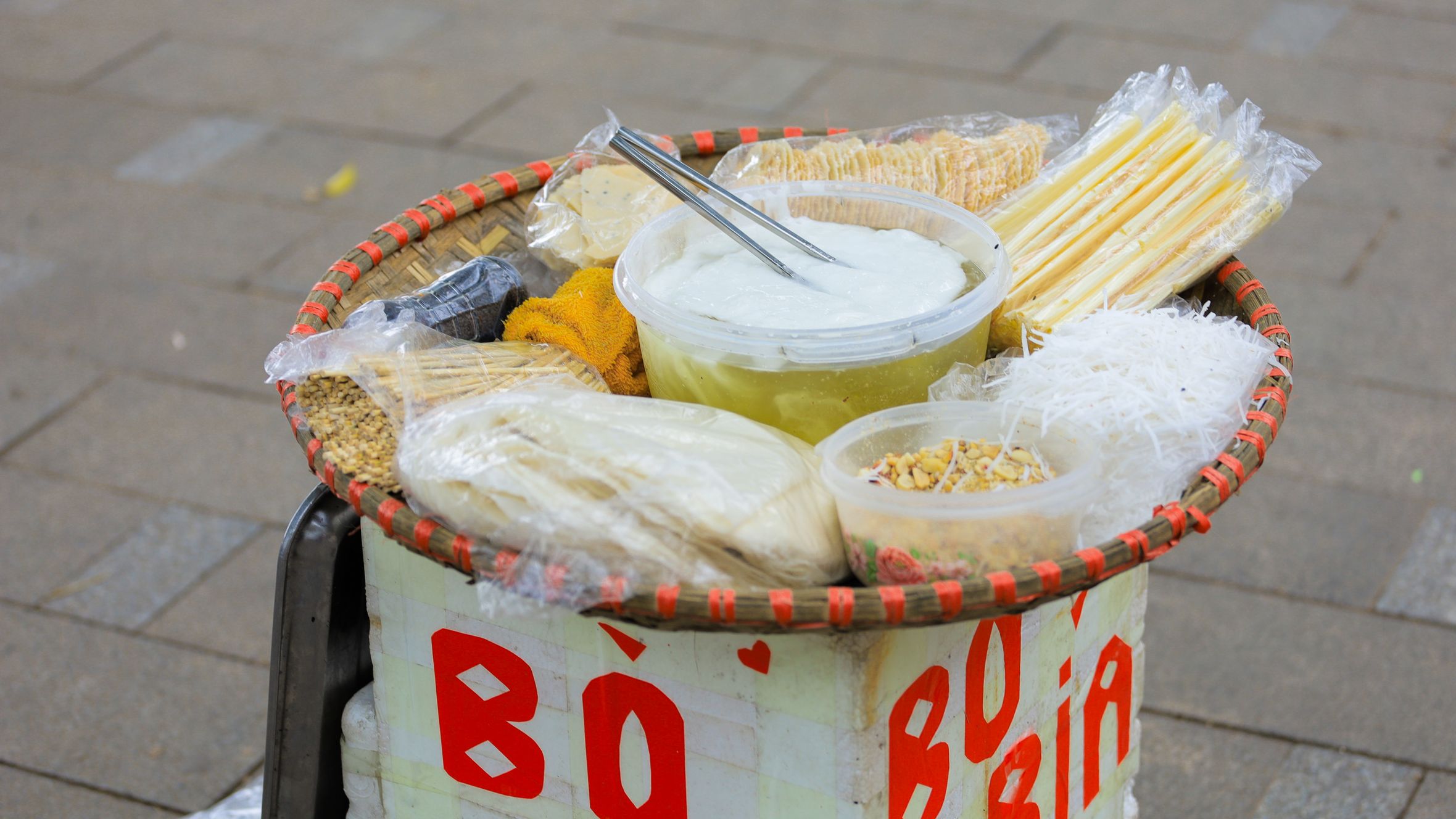 Traditional Vietnamese bò bía snacks displayed outdoors in Hà Nội, Vietnam.
