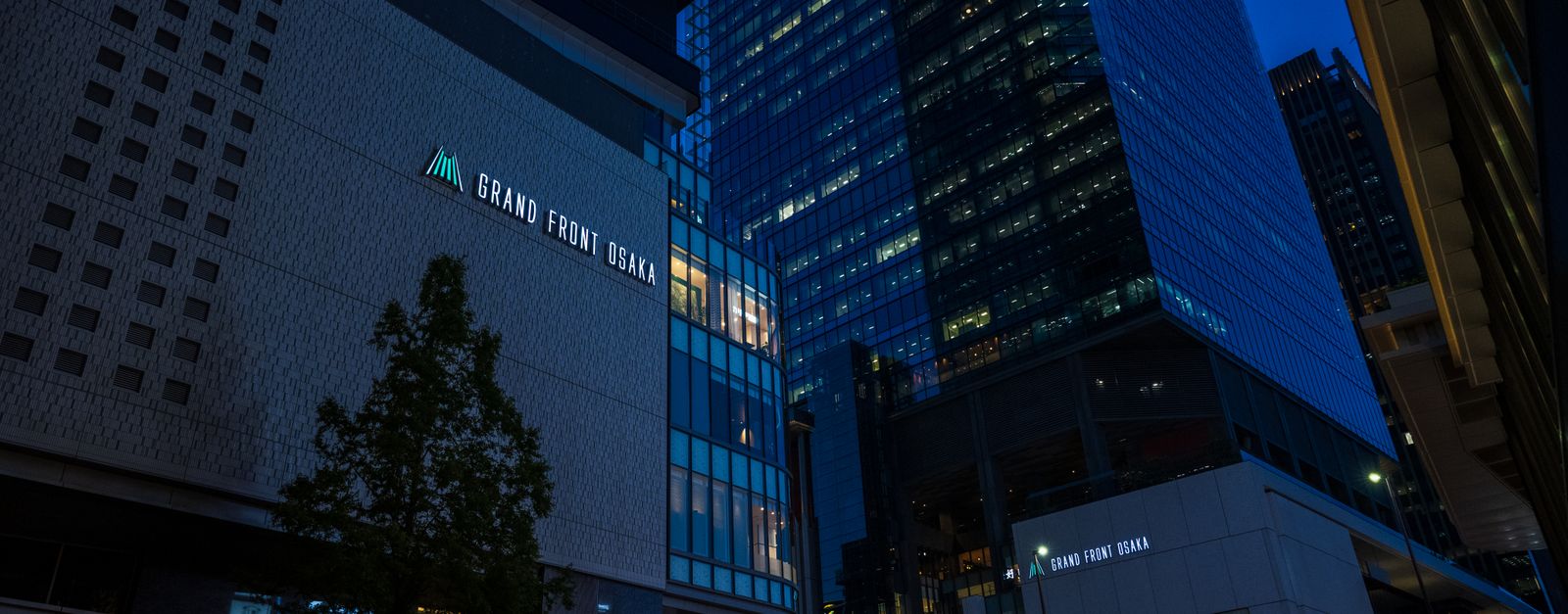 Night view of Grand Front Osaka showcasing sleek architecture and vibrant city lights.