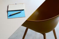 Minimalist Workspace with Notebook and Chair