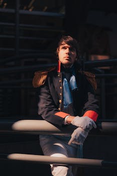 Man in a 19th-century military uniform, leaning in dramatic lighting.
