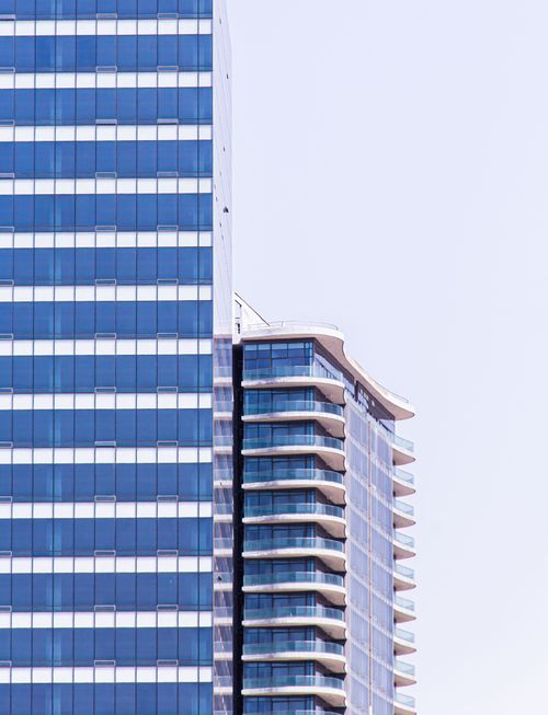 Free Close-up of modern skyscrapers with reflective glass windows and balconies, showcasing urban architecture. Stock Photo