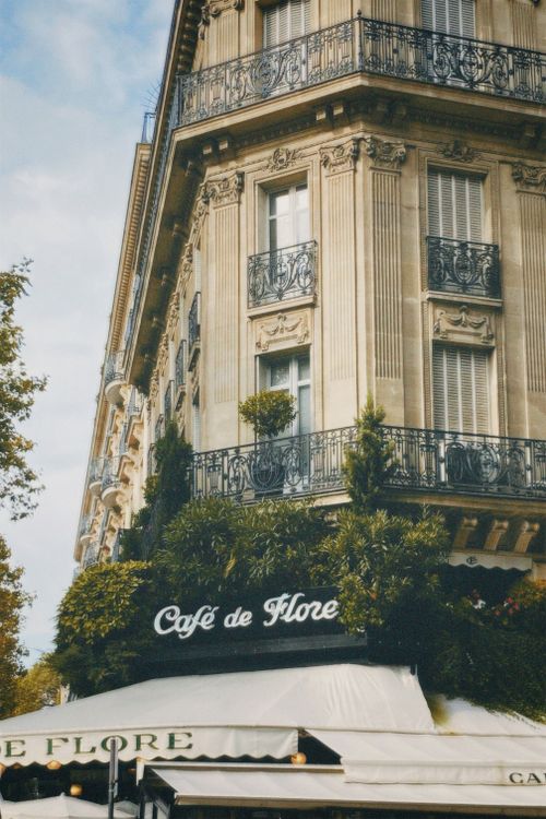Free Elegant facade of Cafe de Flore, iconic historic café in Paris, France, known for its classic architecture and rich history. Stock Photo