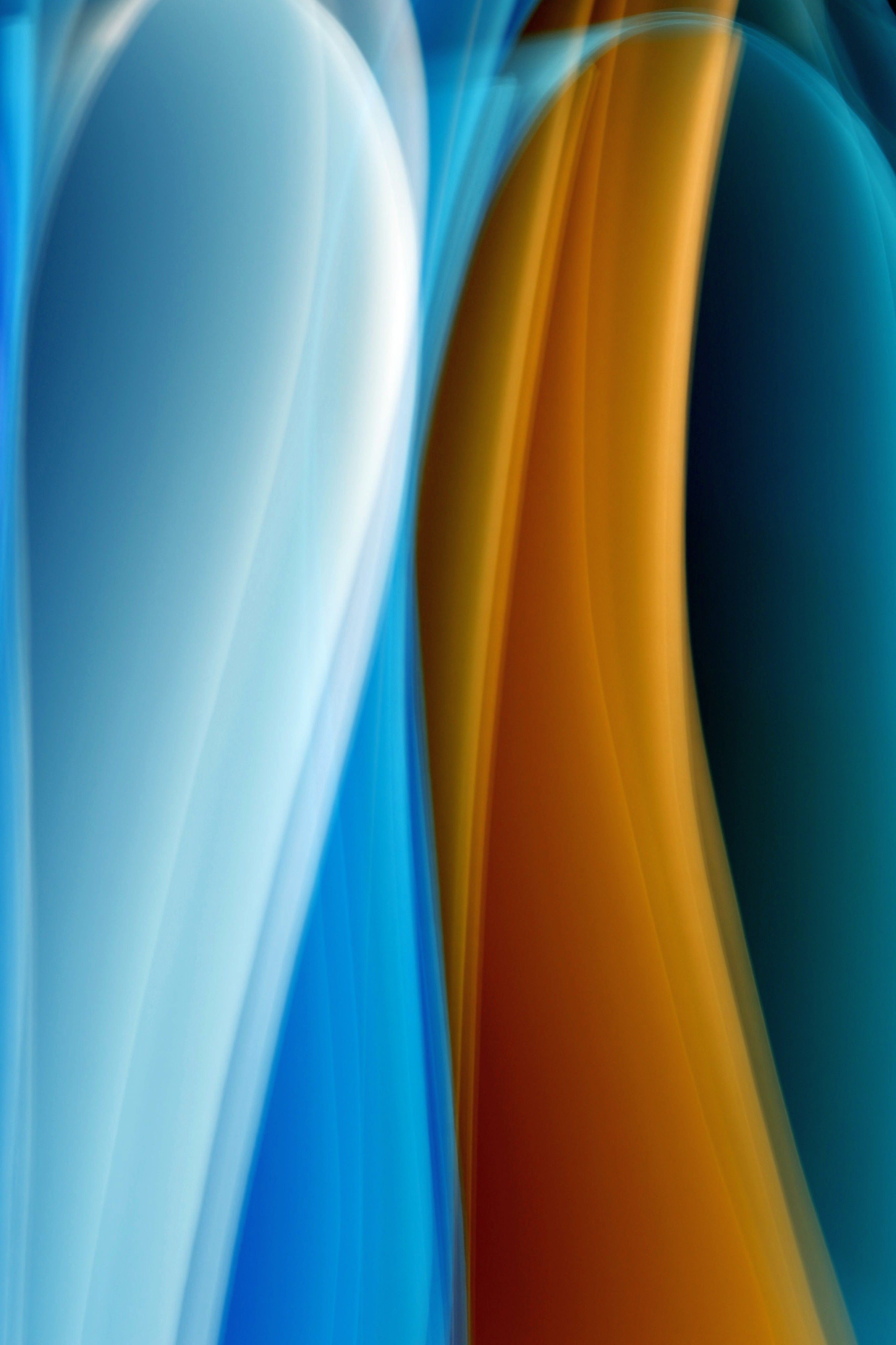 Dynamic abstract artwork featuring blue and orange swirling waves with a smooth gradient effect.